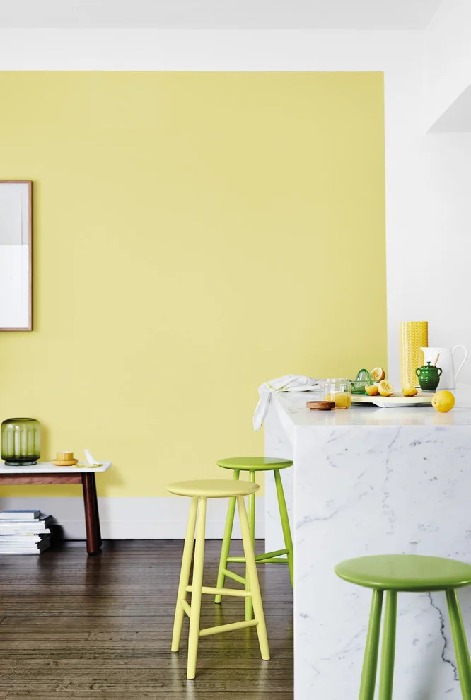 Kitchen Wall Paint Yellow Shades With Mix Match Stools and Marble Countertop