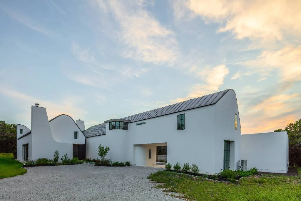 White Stucco Exterior With Gambrel Metal Roof