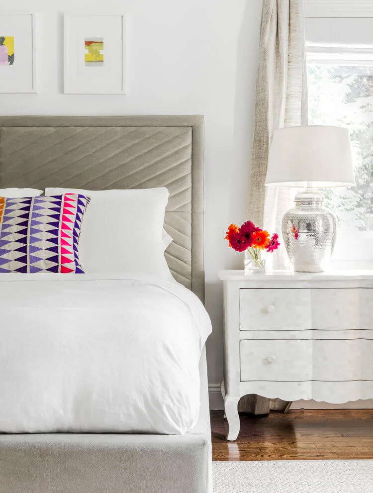 grey bed and side lamp