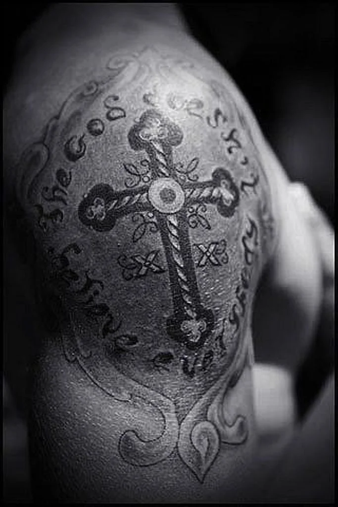 Cross tattoo on shoulder