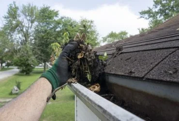 Cleaning Gutters Filled With Leaves & Sticks