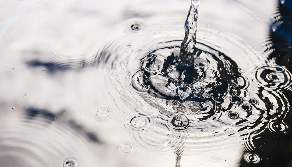 Rainwater harvesting in a large polymer tank on the terrace of a house. Ripples on the surface of water. Aquaphobia – fear of water.