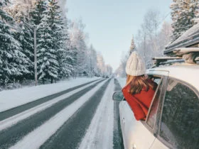 Magic car trip on the road by winter forest covered by snow